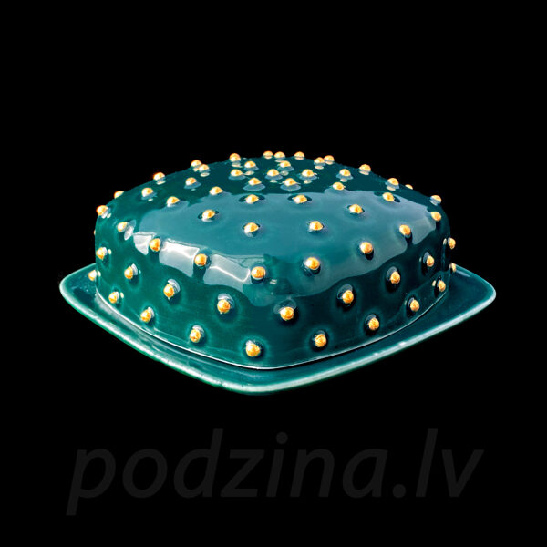 Zaļš sviesta trauks ar zelta pumpiņām