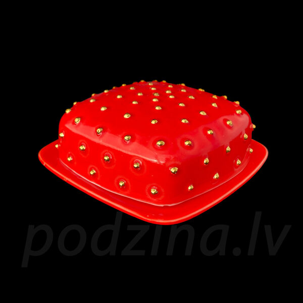 Sarkans sviesta trauks ar zelta pumpiņām